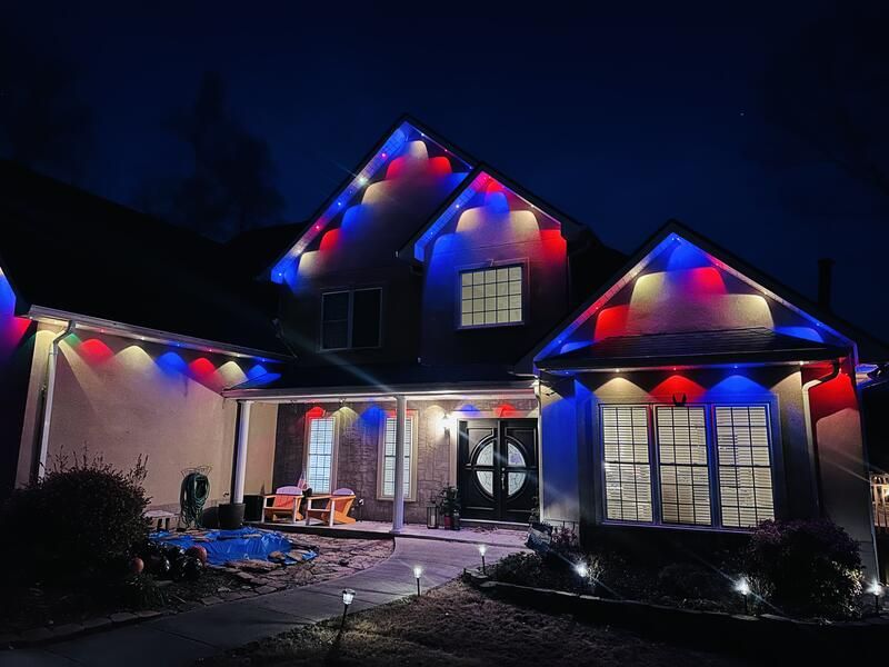 Red white and blue C9 Christmas lights on two story home at night