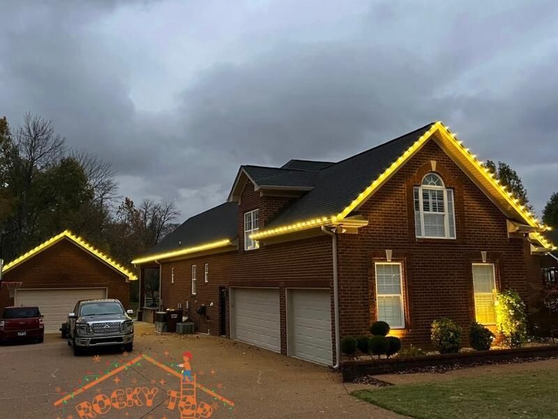 Warm gold C9 Christmas lights on large brick home